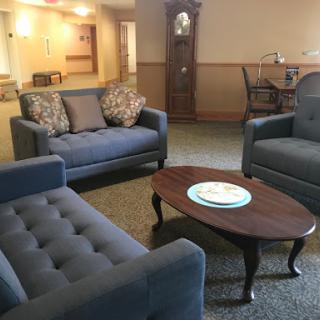 A cozy living room area featuring comfortable couches and a wooden coffee table.