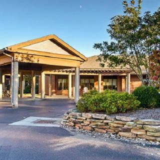 A well-landscaped building entrance with a modern architectural design.