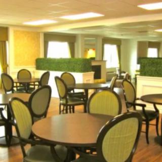 A stylish dining area with round tables and comfortable chairs.