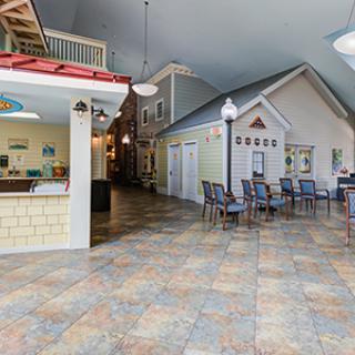A creatively designed indoor space resembling an outdoor street, complete with seating and decorative structures.