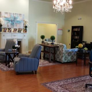 A stylishly furnished living room featuring a chandelier, fireplace, and an array of comfortable seating.