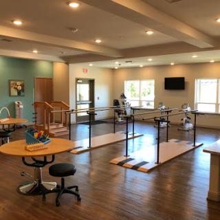 A well-designed physical therapy room equipped with rehabilitation tools and ample natural light.