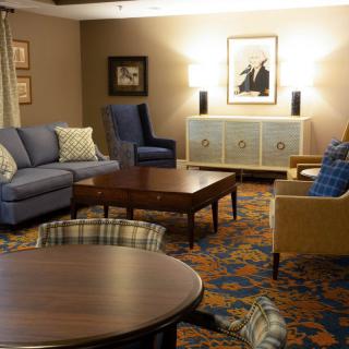 A cozy living room with various seating options and warm decor.