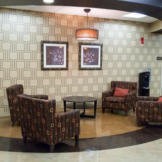 A cozy lobby seating area with armchairs and modern decor.