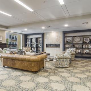 A modern living room with stylish furniture and decorative bookshelves.