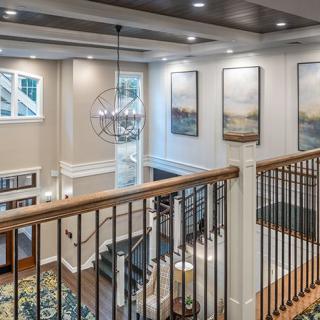 A modern, elegantly designed interior featuring a stylish staircase and contemporary artwork.