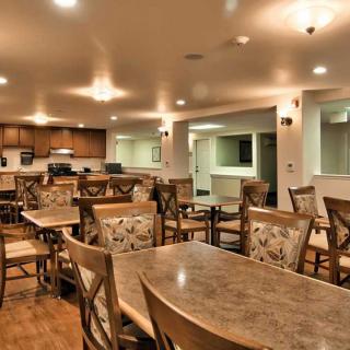 Cozy dining area with neatly arranged tables and chairs.