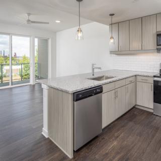 A modern kitchen with stainless steel appliances and a spacious open design.