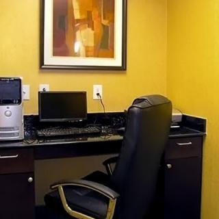 A tidy office space featuring a computer setup on a desk with a comfortable chair.