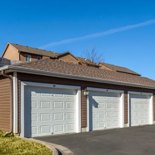 A modern home with a three-car garage and a neatly paved driveway.