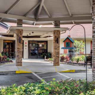 A welcoming entrance with a covered entryway and surrounding greenery.