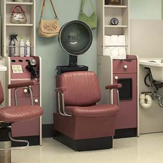 A retro hair salon setup with chairs and a vintage hair dryer.