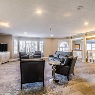 A spacious living room with modern furniture and large windows.