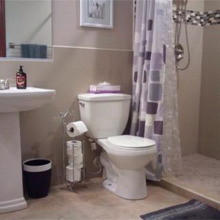 A well-organized bathroom with a toilet, sink, and shower.