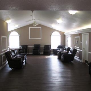 A spacious lounge area with comfortable seating and ample natural light.