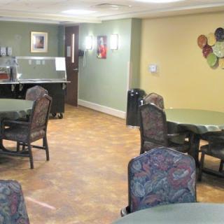 A cozy dining area featuring tables and chairs, ideal for communal meals.