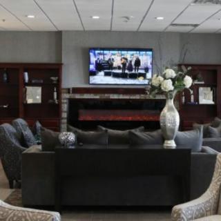 A modern lobby with comfortable seating and a television.