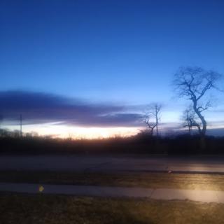 A serene evening sky painted with the warm hues of sunset.