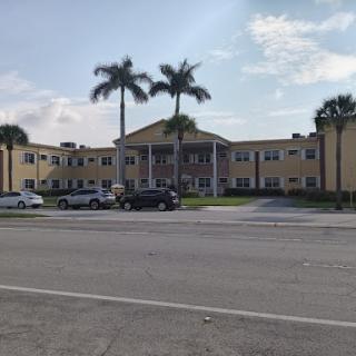A pleasant view of a modern building surrounded by palm trees on a sunny day.