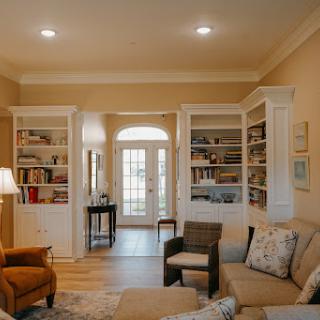 A warm and inviting living room with built-in bookshelves and comfortable seating.