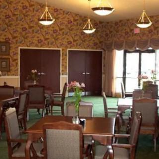 A cozy dining room with elegant furniture and lighting.