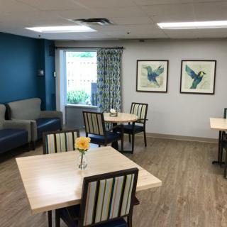 A cozy dining area with modern furniture and decorative artwork on the walls.