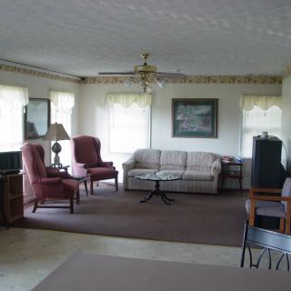 A cozy living room with a sofa, armchairs, and a coffee table.