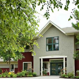 A charming residential house surrounded by lush greenery.