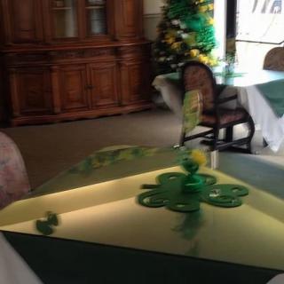 A festive table setting with St. Patrick's Day decorations in a restaurant interior.