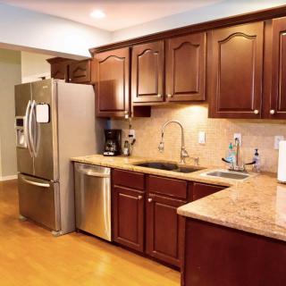 A modern kitchen with wooden cabinets and stainless steel appliances.