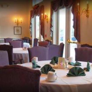 Elegant restaurant dining area with neatly set tables and cozy ambiance.