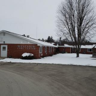A brick building surrounded by snow on a chilly winter day.