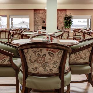 An elegantly furnished dining area with patterned chairs and neatly set tables.