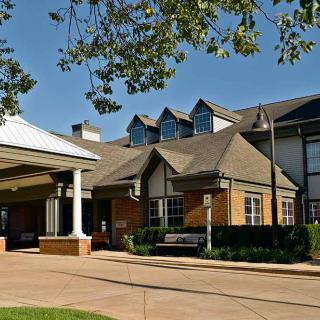 A modern residential building with a welcoming entrance and well-maintained landscaping.