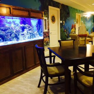 A beautifully decorated dining area featuring a large aquarium.