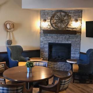 A cozy living room with a stone fireplace and comfortable seating arrangement.