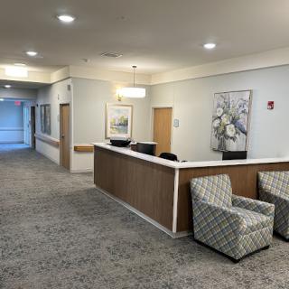 A welcoming reception area featuring comfortable seating and decorative wall art.