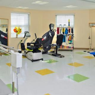 A well-equipped rehabilitation gym featuring various exercise machines and equipment.