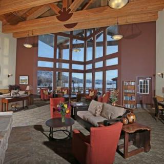 A cozy lounge area with large windows showcasing a mountain view.