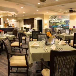 An elegantly decorated restaurant dining area with neatly arranged tables and chairs.
