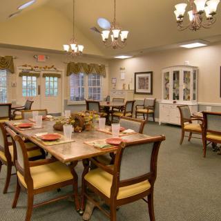 A well-decorated dining room with elegant lighting and furniture.