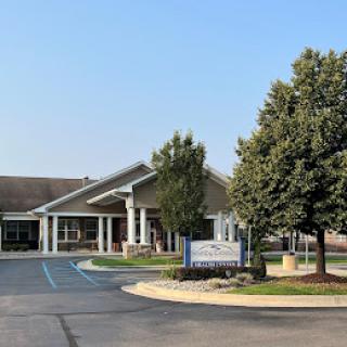 A view of a healthcare facility with a welcoming entrance and landscaped surroundings.