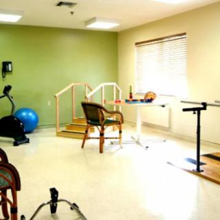 A rehabilitation room equipped with exercise and therapy tools for physical therapy sessions.