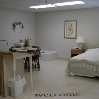 A welcoming and cozy interior space featuring a bed, dining area, and decorative elements.