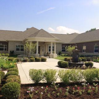 A beautiful residential house with a well-maintained garden and a welcoming front porch.