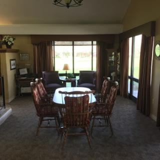 A spacious living and dining area with cozy furniture and natural light.