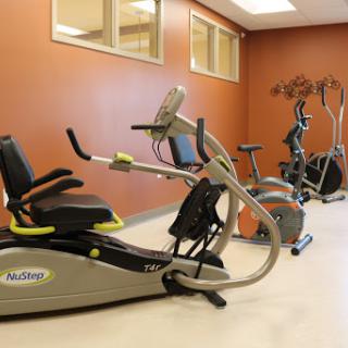 A modern gym space featuring various exercise machines for a complete workout.