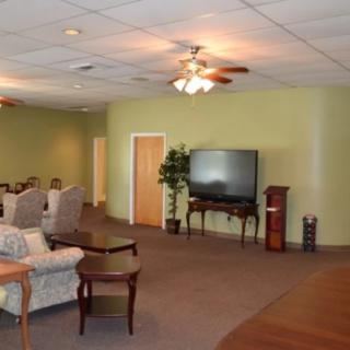 Spacious living area with comfortable seating and a large television.