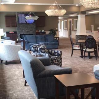 A cozy lounge area with comfortable seating and elegant chandeliers.