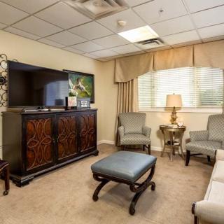 A cozy waiting room with comfortable seating and a TV.